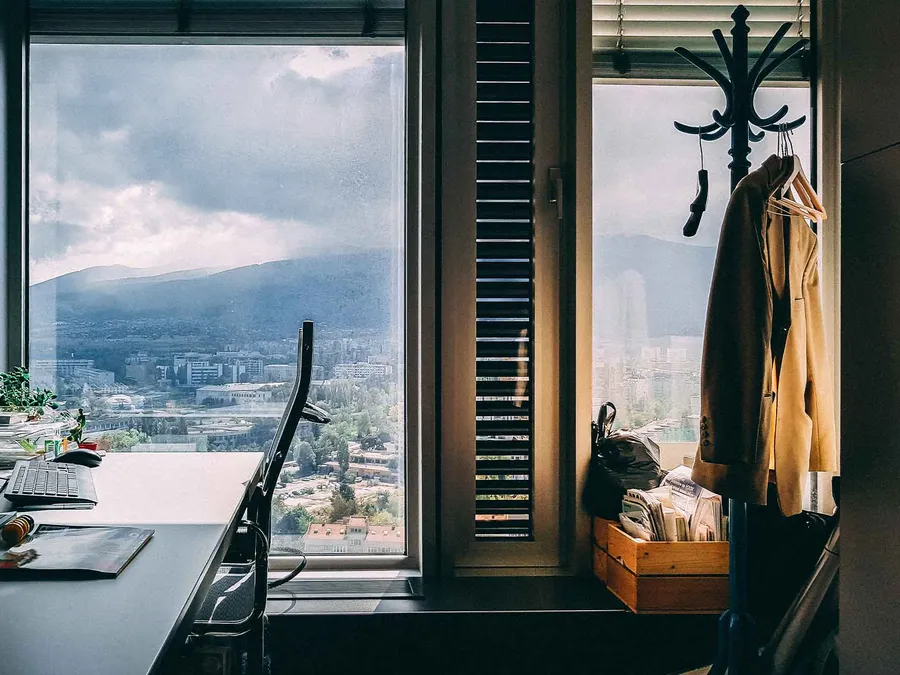 A desk by a window overlooking the city
