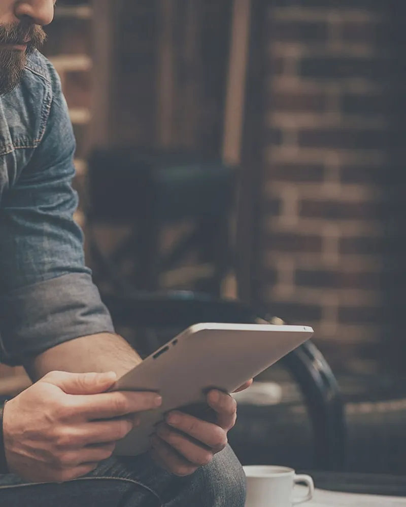 A strategist reviewing a revenue report on a tablet