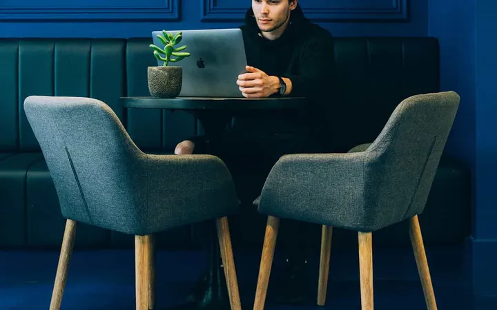 A strategist working alone in a quiet blue room
