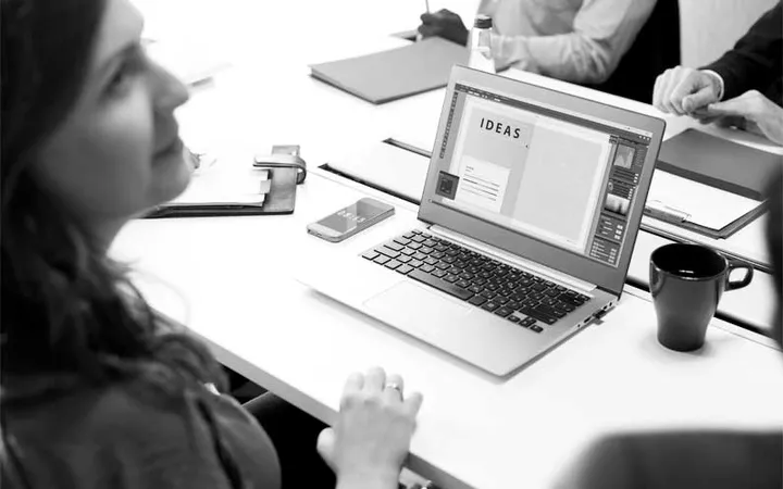 A copywriter sketching messaging ideas at a laptop