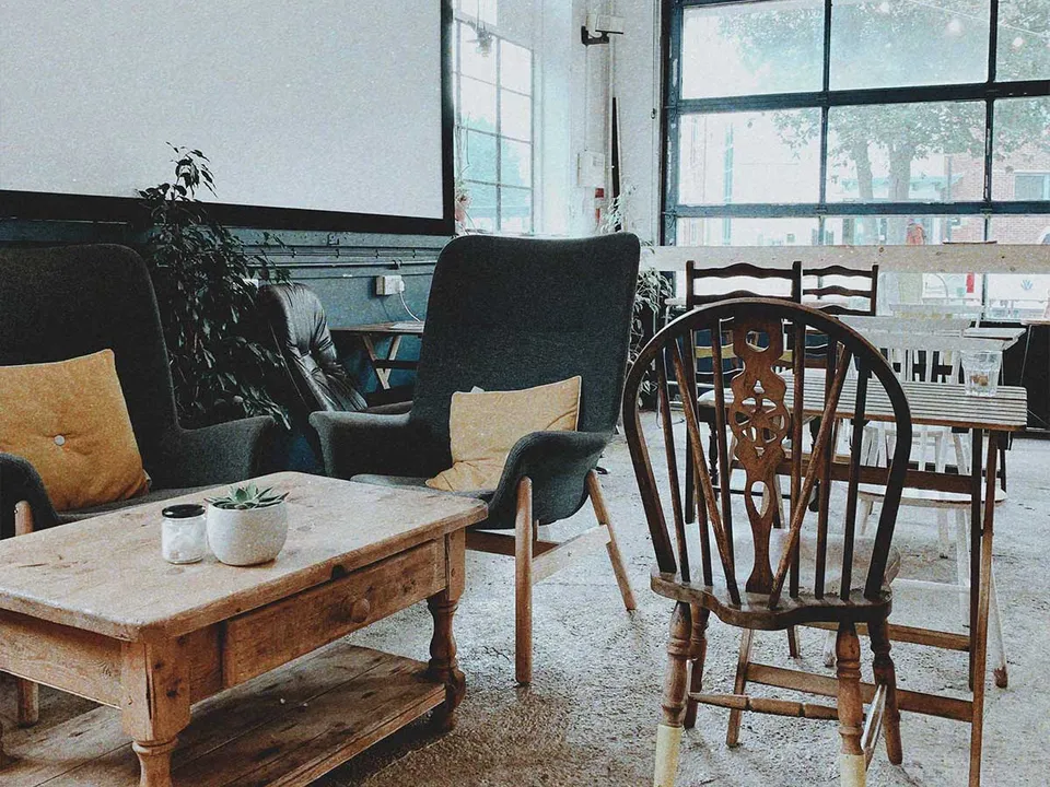 A quiet loft studio with a work table by tall windows